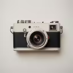 an old camera with a lens attached to it