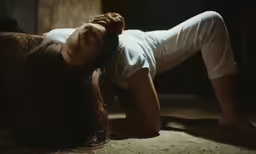 a young woman lays on her side on a bed