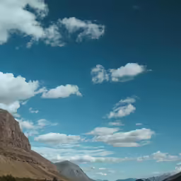 the mountain landscape with blue sky and white clouds