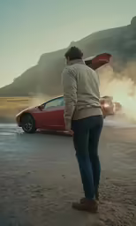 a person watching a sports car and smoke