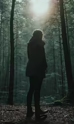 a person is standing in the middle of a forrest