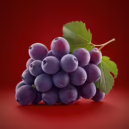 a bunch of grapes that is next to a green leaf