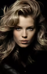 a woman with blond hair looking directly into the camera