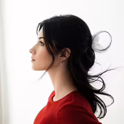 a woman with a messy hair styled into a pony tail