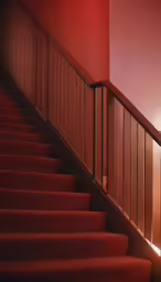 stairs leading up to a light that is shining down on the wall
