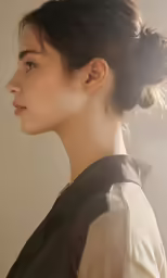 a young woman with hair pulled back in a bun