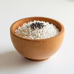 a wood bowl with rice is shown