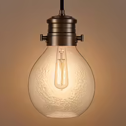 a light bulb hanging from the ceiling on top of a wall