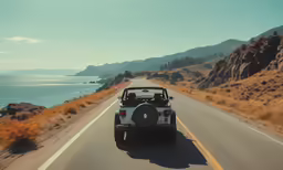 a jeep driving down the highway next to the ocean