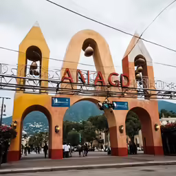 a red and yellow archway on the side of a street