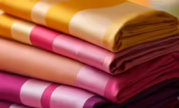 four color striped cloths piled up in neat stacked position