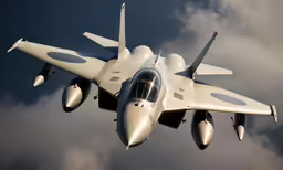 the underside view of a gray and white military fighter jet