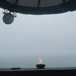 a fire pit with an ocean in the background