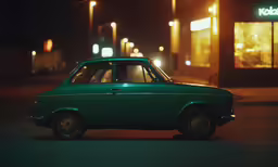 a small green car parked on a street corner