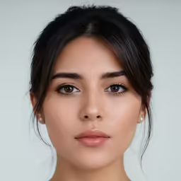 a woman with black hair, wearing a white top and grey eyeshadow