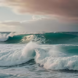 two waves are in the ocean, and one wave has just washed