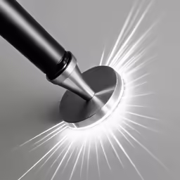 a shiny silver microphone with a black handle