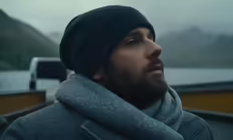 a man wearing a hat and scarf around his neck