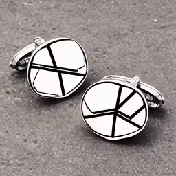 pair of silver cuff - links with black and white geometric design