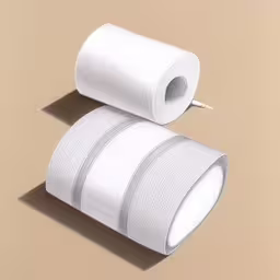 two rolls of fabric are sitting on the floor,two white toilet roll with a paper slot next to one
