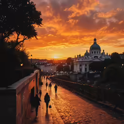 a group of people walking across a street at sunset