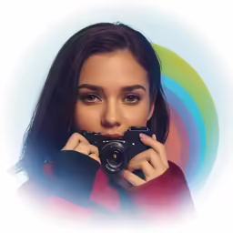 a beautiful woman holding up a camera with an artistic background