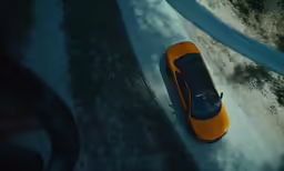 a very small orange car on the ground