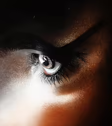 woman with long lashes looking into the distance