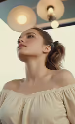 a woman in a tan top is looking upward