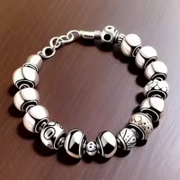 this is a very cute bracelet with a number on it,an item on a wooden table with a wood surface