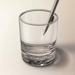 a glass with some pens in it