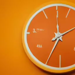 a bright orange clock with the time passing 11 30