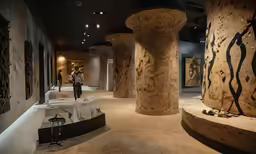 the man is taking pictures of the art in the room