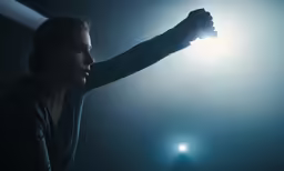 a woman holding a tennis racquet at night