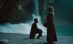 a woman in red is watching a man sit at the side