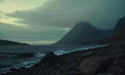 the rocks are on the shore near a body of water