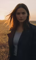 a woman with long hair in a field