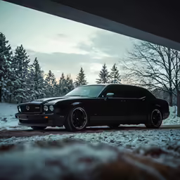 black car parked in a driveway covered in snow