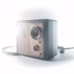 a small camera is placed next to a charger