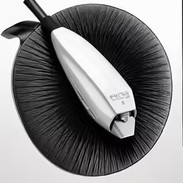 the black and white photo is of a hair dryer on the back of an object