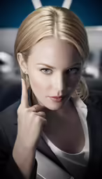 a woman is wearing a suit and holds her hand to her head