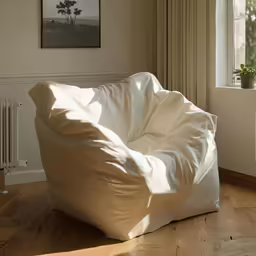 a bean bag sitting in a corner with a window