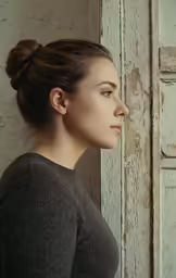 a woman in a black top looking out the window