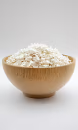 a bowl filled with cereal and a knife