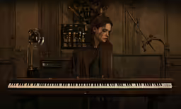 the person is sitting at a keyboard, playing the piano