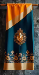 there is an orange skull hanging on a blue and gold towel