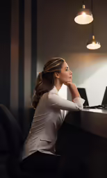 a beautiful woman in tight pants leaning on a desk with her head propped up