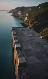 large long rectangular, concrete blocks sit beside the water
