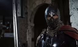the man in armor is standing in a doorway