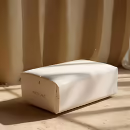 white box sitting on brown floor in light